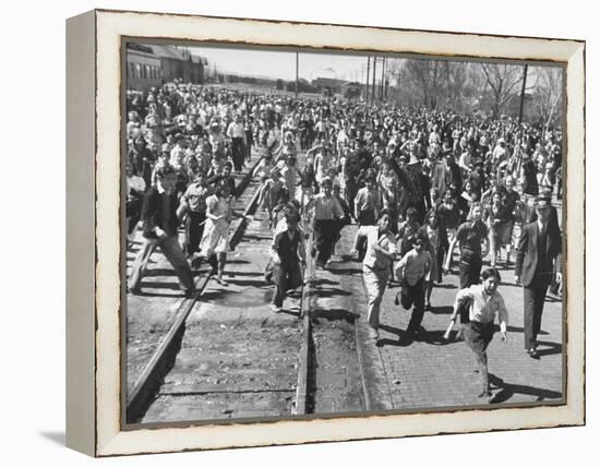 A Large Crowd of People Running Through the Streets During the Dodge City Parade-Peter Stackpole-Framed Premier Image Canvas