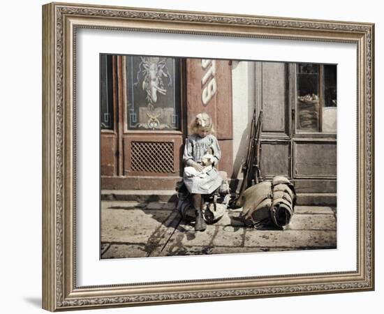 A Little Girl Playing with Her Doll; Two Guns and a Knapsack are Next to He-Fernand Cuville-Framed Giclee Print