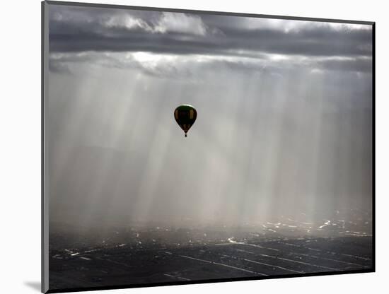 A Lone Balloon Drifts Near the Foothills of Albuquerque, N.M.-null-Mounted Photographic Print