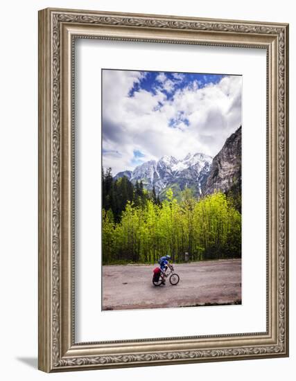 A Lone Cyclist Travels Along a Mountain Road with Trees and the Julian Alps in the Background-Sean Cooper-Framed Photographic Print