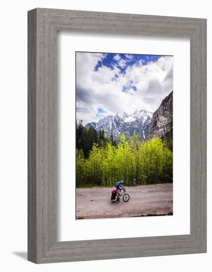 A Lone Cyclist Travels Along a Mountain Road with Trees and the Julian Alps in the Background-Sean Cooper-Framed Photographic Print