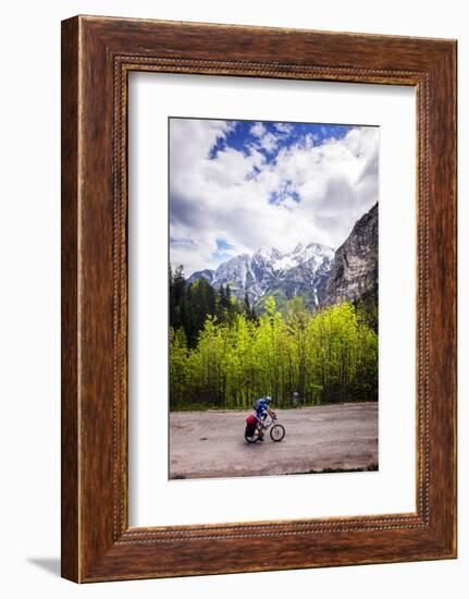 A Lone Cyclist Travels Along a Mountain Road with Trees and the Julian Alps in the Background-Sean Cooper-Framed Photographic Print