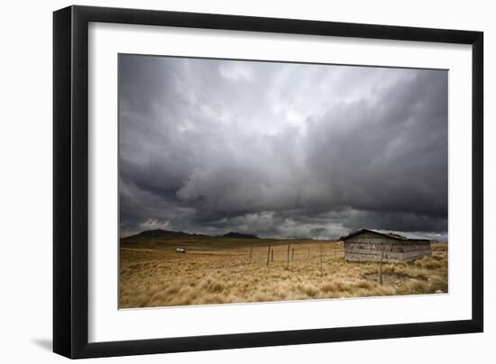 A Lone Hut Sits In The Grass As Storm Clouds Brew Over The Peruvian Countryside-Karine Aigner-Framed Photographic Print