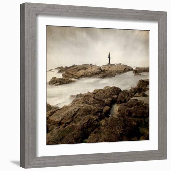 A Lone Man Standing on Large Rocks with the Seas Swirling around Them-Luis Beltran-Framed Photographic Print
