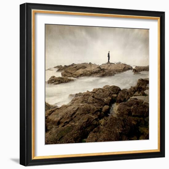 A Lone Man Standing on Large Rocks with the Seas Swirling around Them-Luis Beltran-Framed Photographic Print