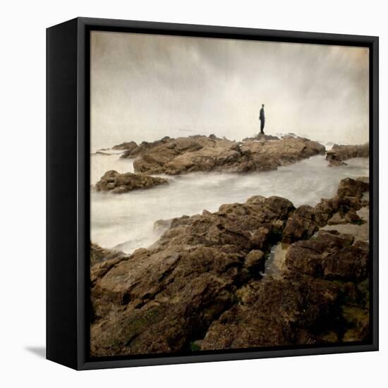 A Lone Man Standing on Large Rocks with the Seas Swirling around Them-Luis Beltran-Framed Premier Image Canvas