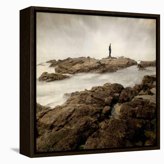 A Lone Man Standing on Large Rocks with the Seas Swirling around Them-Luis Beltran-Framed Premier Image Canvas