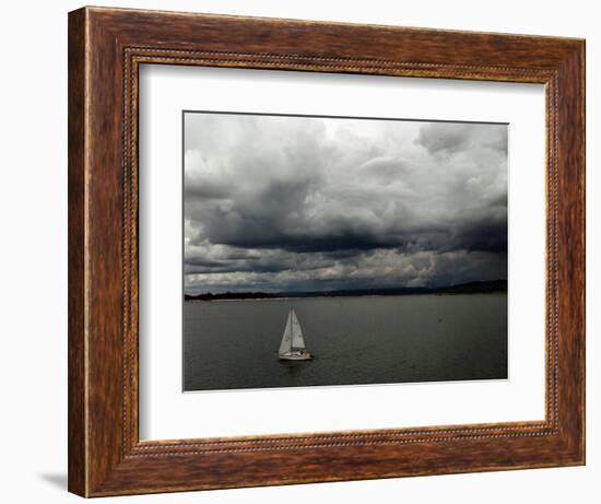 A Lone Sailboat Makes its Way Along Folsom Lake as Heavy Storm Clouds Approach-null-Framed Photographic Print