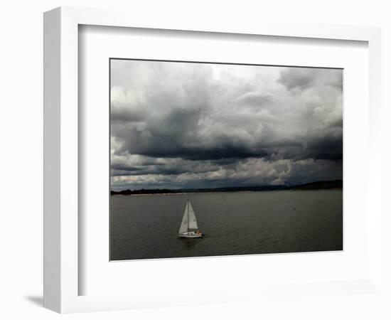 A Lone Sailboat Makes its Way Along Folsom Lake as Heavy Storm Clouds Approach-null-Framed Photographic Print