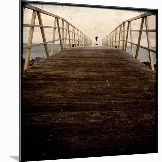 A Long Wooden Walkway at the Sea with a Figure Standing in the Distance-Luis Beltran-Mounted Photographic Print