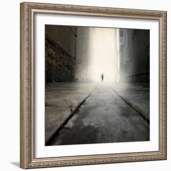 A Low Level View of a Boy Running Along the Street-Luis Beltran-Framed Photographic Print