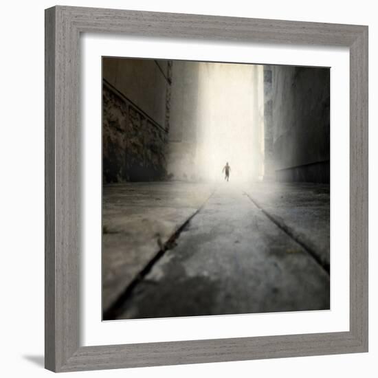 A Low Level View of a Boy Running Along the Street-Luis Beltran-Framed Photographic Print