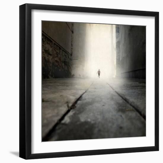 A Low Level View of a Boy Running Along the Street-Luis Beltran-Framed Photographic Print