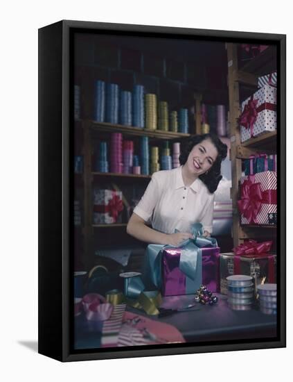 A Macy's Employee Ties a Bow onto a Present at a Gift Wrapping Counter, New York, New York, 1948-Nina Leen-Framed Premier Image Canvas