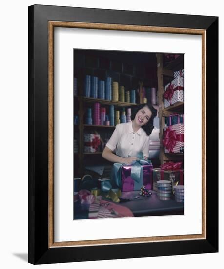 A Macy's Employee Ties a Bow onto a Present at a Gift Wrapping Counter, New York, New York, 1948-Nina Leen-Framed Photographic Print