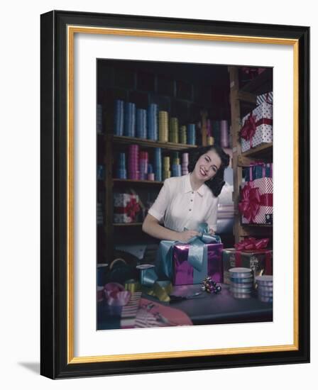 A Macy's Employee Ties a Bow onto a Present at a Gift Wrapping Counter, New York, New York, 1948-Nina Leen-Framed Photographic Print