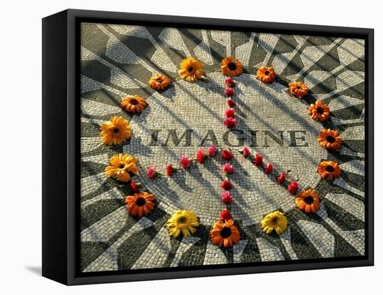 A Makeshift Peace Sign of Flowers Lies on Top John Lennon's Strawberry Fields Memorial-null-Framed Premier Image Canvas