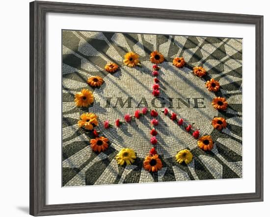 A Makeshift Peace Sign of Flowers Lies on Top John Lennon's Strawberry Fields Memorial-null-Framed Premium Photographic Print