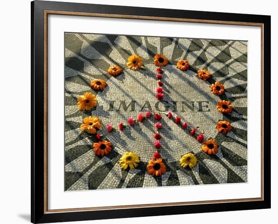 A Makeshift Peace Sign of Flowers Lies on Top John Lennon's Strawberry Fields Memorial-null-Framed Premium Photographic Print