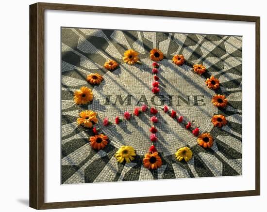 A Makeshift Peace Sign of Flowers Lies on Top John Lennon's Strawberry Fields Memorial-null-Framed Premium Photographic Print