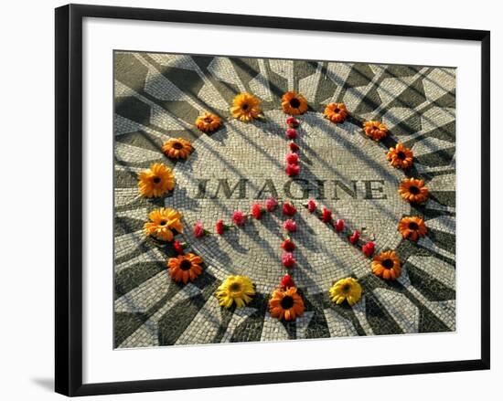 A Makeshift Peace Sign of Flowers Lies on Top John Lennon's Strawberry Fields Memorial-null-Framed Premium Photographic Print