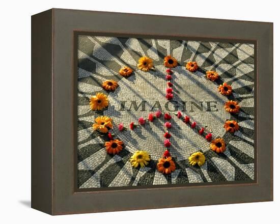 A Makeshift Peace Sign of Flowers Lies on Top John Lennon's Strawberry Fields Memorial-null-Framed Premier Image Canvas