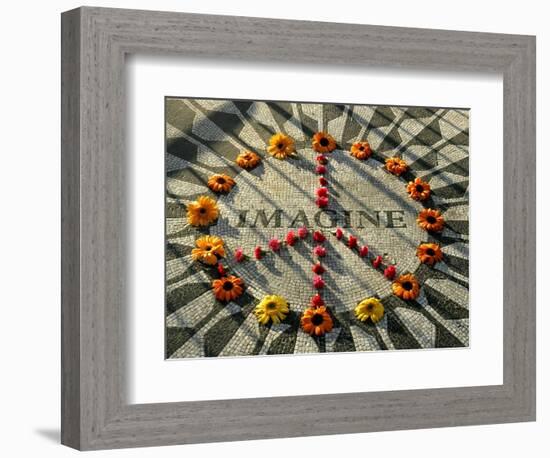 A Makeshift Peace Sign of Flowers Lies on Top John Lennon's Strawberry Fields Memorial-null-Framed Photographic Print