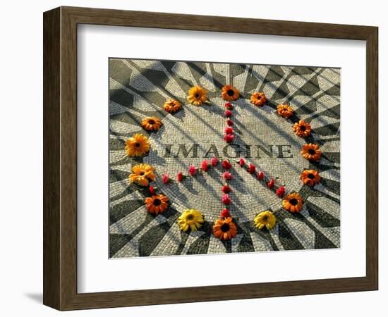 A Makeshift Peace Sign of Flowers Lies on Top John Lennon's Strawberry Fields Memorial--Framed Photographic Print