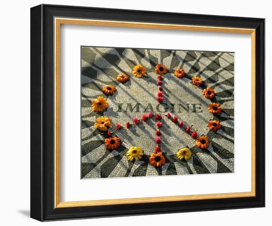 A Makeshift Peace Sign of Flowers Lies on Top John Lennon's Strawberry Fields Memorial--Framed Photographic Print