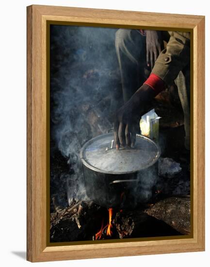 A Man, 24, from Ghana, Prepares His Meal-null-Framed Premier Image Canvas