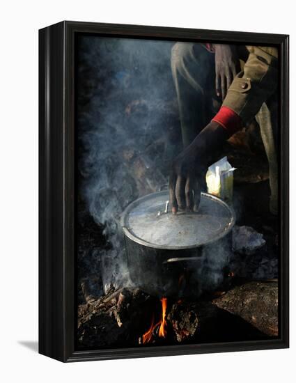 A Man, 24, from Ghana, Prepares His Meal-null-Framed Premier Image Canvas