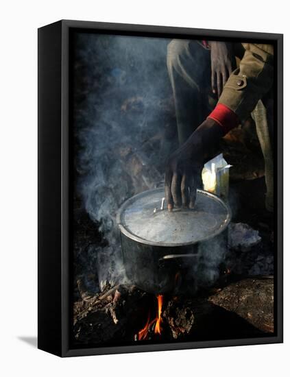 A Man, 24, from Ghana, Prepares His Meal-null-Framed Premier Image Canvas