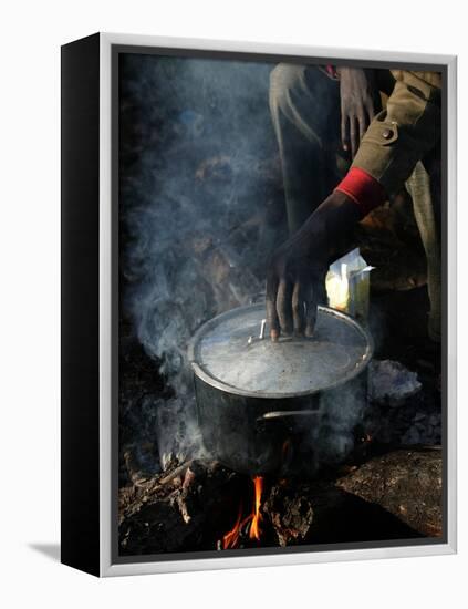A Man, 24, from Ghana, Prepares His Meal-null-Framed Premier Image Canvas