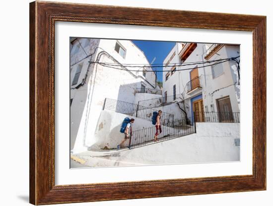 A Man And A Woman Trek Through The Medieval Streets Of Chulilla, Spain-Ben Herndon-Framed Photographic Print