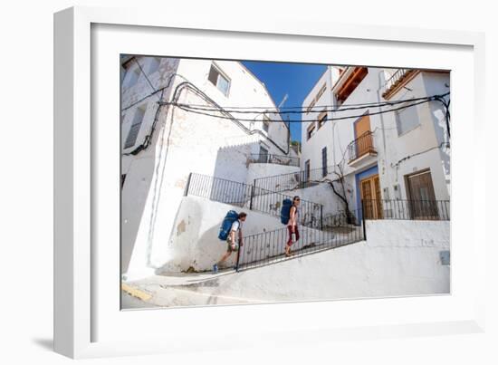 A Man And A Woman Trek Through The Medieval Streets Of Chulilla, Spain-Ben Herndon-Framed Photographic Print