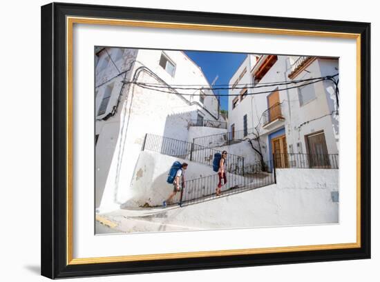 A Man And A Woman Trek Through The Medieval Streets Of Chulilla, Spain-Ben Herndon-Framed Photographic Print