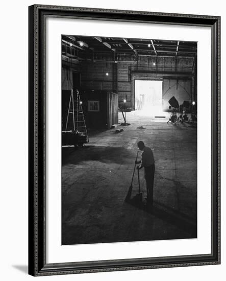 A Man Cleaning Up the Empty Sound Stage-null-Framed Photographic Print