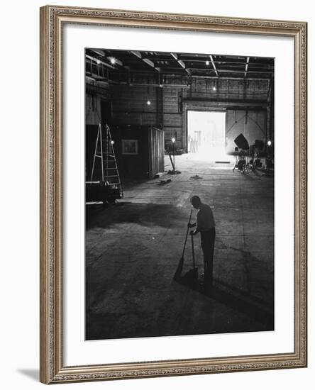 A Man Cleaning Up the Empty Sound Stage-null-Framed Photographic Print