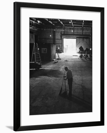 A Man Cleaning Up the Empty Sound Stage-null-Framed Photographic Print