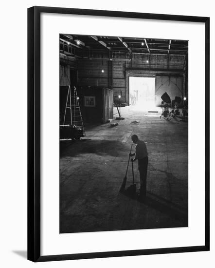 A Man Cleaning Up the Empty Sound Stage-null-Framed Photographic Print