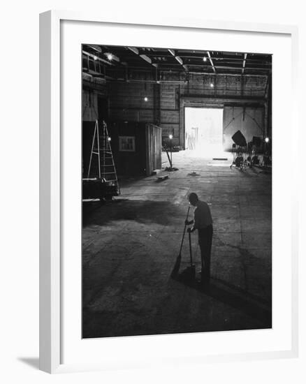 A Man Cleaning Up the Empty Sound Stage-null-Framed Photographic Print