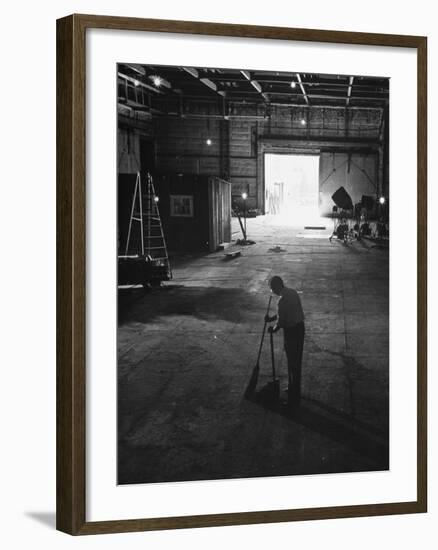 A Man Cleaning Up the Empty Sound Stage-null-Framed Photographic Print