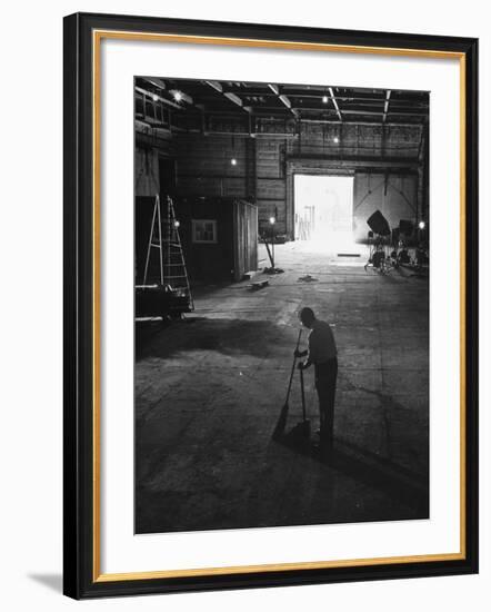 A Man Cleaning Up the Empty Sound Stage-null-Framed Photographic Print