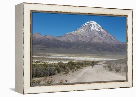 A Man Cycles in the Shadow of Sajama Volcano in Sajama National Park-Alex Saberi-Framed Premier Image Canvas