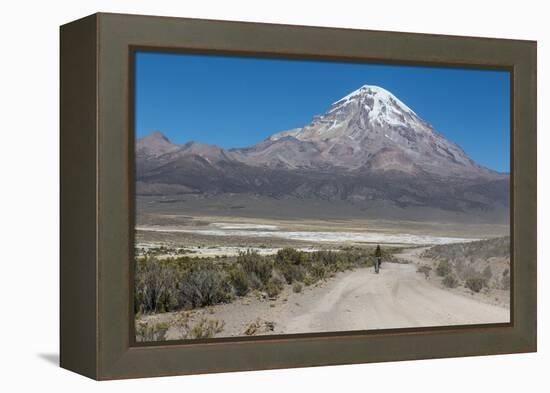 A Man Cycles in the Shadow of Sajama Volcano in Sajama National Park-Alex Saberi-Framed Premier Image Canvas