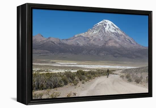 A Man Cycles in the Shadow of Sajama Volcano in Sajama National Park-Alex Saberi-Framed Premier Image Canvas