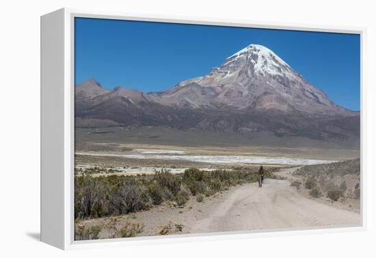 A Man Cycles in the Shadow of Sajama Volcano in Sajama National Park-Alex Saberi-Framed Premier Image Canvas