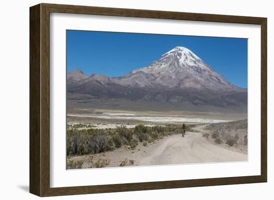 A Man Cycles in the Shadow of Sajama Volcano in Sajama National Park-Alex Saberi-Framed Photographic Print