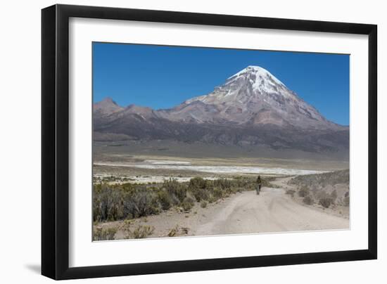 A Man Cycles in the Shadow of Sajama Volcano in Sajama National Park-Alex Saberi-Framed Photographic Print