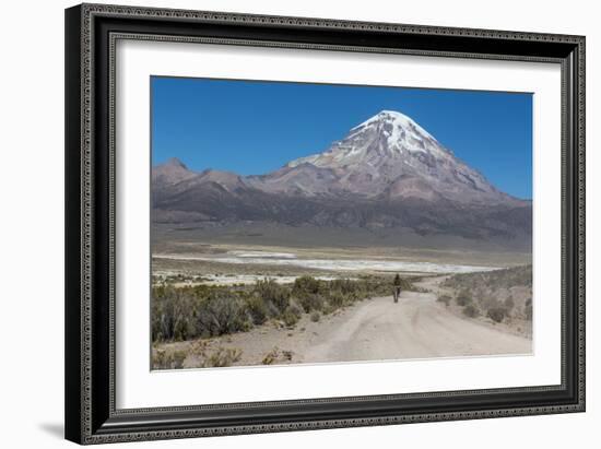 A Man Cycles in the Shadow of Sajama Volcano in Sajama National Park-Alex Saberi-Framed Photographic Print